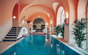 a large swimming pool in a building with a swimming pool at the eighteen86 by keyone in Bad Gastein