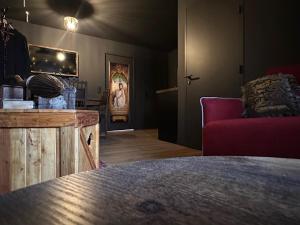 a living room with a red couch and a painting at Le Nimbus by Clem in Pélussin +36 photos