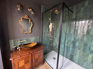 a bathroom with a glass shower and a sink at Le Nimbus by Clem in Pélussin