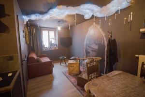 a living room with a bed and a cloud on the wall at Le Nimbus by Clem in Pélussin