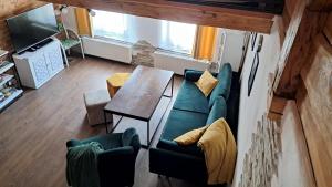 a living room with a couch and a table at Loft Szczytna in Szczytna