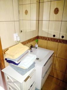 a bathroom with a white sink and a shower at Loft Szczytna in Szczytna +17 photos