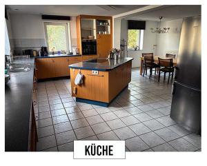 a kitchen with a island in the middle of a room at Landhaus in Springe