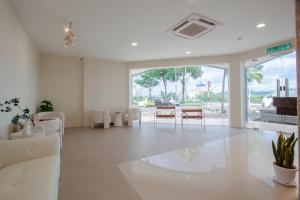 a living room with white furniture and a table at Blenz Hotel in Serdang