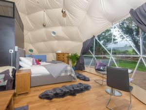 a bedroom with a bed in a tent at Gwenllian in Machynlleth