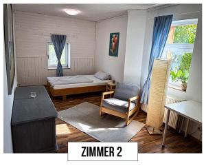 a small room with a bed and a chair at Landhaus in Springe
