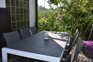 a black table and chairs on a patio at Ferienwohnung Wiedergrün in Durbach