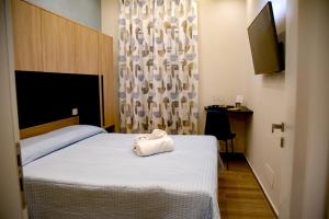 a hotel room with a bed with a towel on it at Fiore dei Templi - luxury suite experience in Agrigento