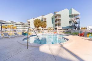 a swimming pool with a slide in front of a building at Baywatch D11 in Pensacola Beach