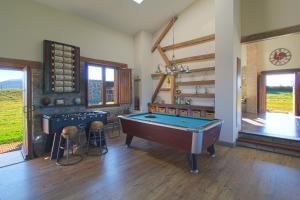 a living room with a pool table and two stools at Casona Alto Sarracin in Lloreda