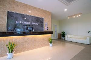 a lobby with a large screen on a wall at Blenz Hotel in Serdang
