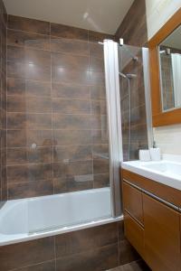 a bathroom with a shower and a sink at La Casa del Muelle in Suances