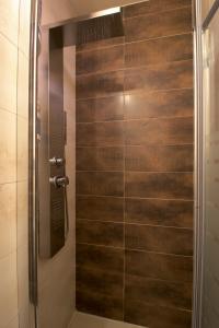 a shower with a glass door in a bathroom at La Casa del Muelle in Suances