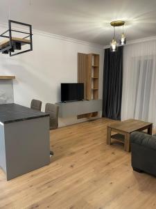 a living room with a couch and a table at Apartament in Ipotești in Ipoteşti