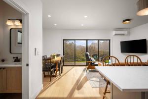 a kitchen and dining room with a table and chairs at Lake & Laughter Unit 2 in Rockaway Beach