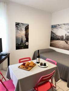 a table with a plate of bread and a bottle of wine at SWEET APT Piazza Statuto 9 Deluxe NEL PIENO CENTRO DI TORINO in Turin