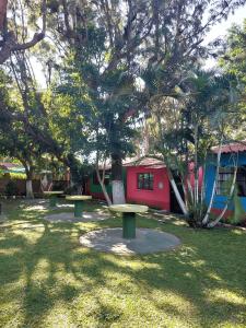 a park with two benches in front of a tree at El Aguacatal in Panajachel