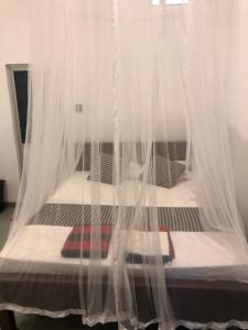 Postel nebo postele na pokoji v ubytování Green House Ahangama