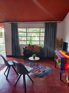 a living room with a couch and a table at El Aguacatal in Panajachel