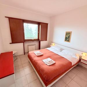 Postel nebo postele na pokoji v ubytování Baita Arancio By DomusExtra