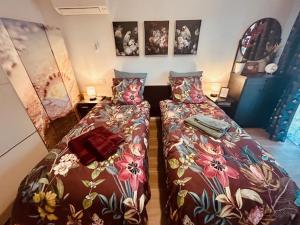 1 dormitorio con 2 camas con flores en Résidences des Peyrons vue exceptionnelle mer et sur les Iles d'Or, en Carqueiranne 82 fotos más