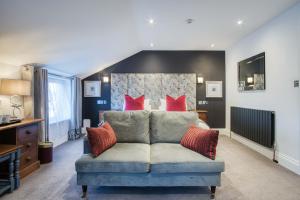 a living room with a couch with red pillows at The Helaina in Scarborough