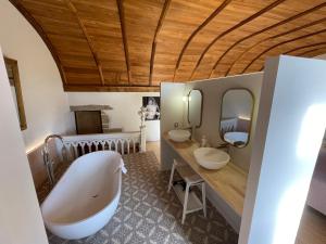 a large bathroom with two sinks and a large tub at Manoir de Kerenneur in Plourin +63 photos