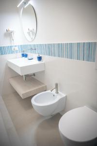 ein weißes Badezimmer mit Toilette und Waschbecken in der Unterkunft Le Cromie di Amelie in Ceglie Messapica