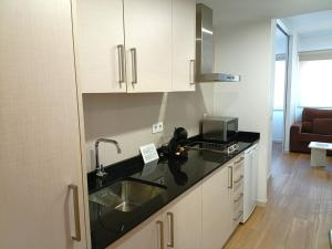 a kitchen with a sink and a counter top at Marynton Boutique in Benicarló