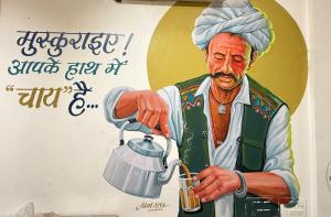 a painting of a man holding a pot at Nahargarh view Hotel in Jaipur