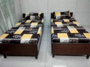 Postel nebo postele na pokoji v ubytování Chauhan Delighted Residence