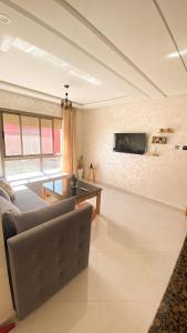 a living room with a couch and a table at Imsouane Sea surf Camp in Imsouane