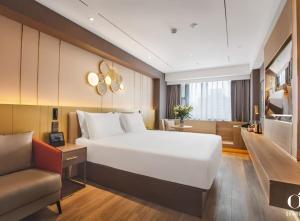 a bedroom with a large white bed and a couch at Orange Hotel Beijing Yansha Landmark River in Beijing +43 photos
