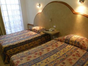 Postel nebo postele na pokoji v ubytování Hotel Fenix + 34 fotografií