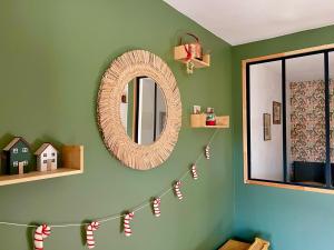 a room with a mirror and a string of christmas socks at La Poulie - Apartment with Balcony and Free Privative Parking - Close to Colmar in Sainte-Croix-en-Plaine