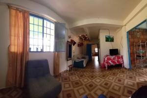 a living room with a chair and a window at Villa Celeste in Páramo