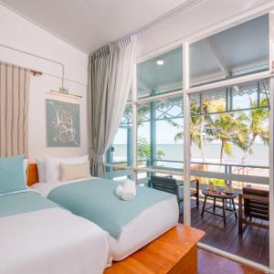 a bedroom with a bed and a view of the ocean at Oceanfront Colonial Beach Villa 6Bedrooms, Sleeps 28 in Hua Hin +114 photos