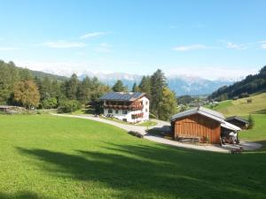 an aerial view of a building in a green field at Riedhof in Mieders