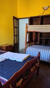 two beds in a room with yellow walls at Humadepto in Humahuaca
