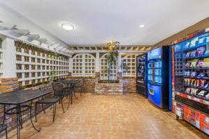 a restaurant with tables and chairs and a vending machine at Best Western Plus Carriage Inn in Sherman Oaks