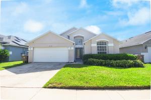 a house with a garage in a residential neighborhood at Casa Kissimmee in Orlando