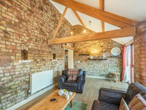 a living room with a brick wall at The Tack Rooms - Uk37520 in Routh