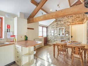 a kitchen and dining room with a table and chairs at The Tack Rooms - Uk37520 in Routh
