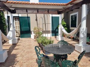 an outdoor patio with a table and chairs at BREJOS DA COMENDA by Stay in Alentejo in Vila Nova de Milfontes