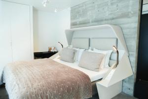 a bedroom with a white bed and a wooden wall at Boutique Hotel Herman K in Copenhagen +61 photos
