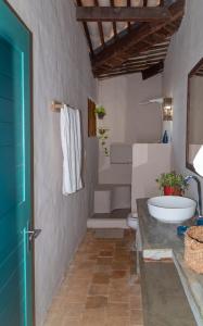 a bathroom with a sink and a toilet at Casa Paracatoá - Icapuí in Icapuí
