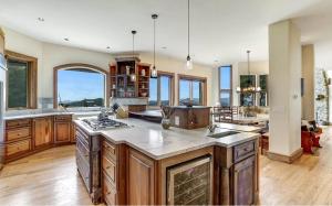 a large kitchen with wooden cabinets and a large island at Sunrise to Sunset in Hayesville