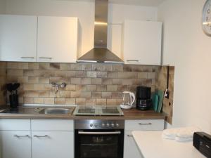 a kitchen with a sink and a stove top oven at Ferienwohnung Bilstein in Bilstein