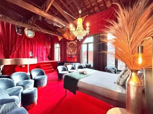 a bedroom with a bed and some blue chairs at 10 Très Grande Chambre insolite double volume XL, proximité gare de tourcoing in Tourcoing