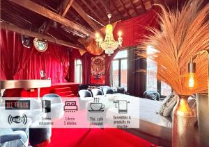 a room with red curtains and a table and chairs at 10 Très Grande Chambre insolite double volume XL, proximité gare de tourcoing in Tourcoing